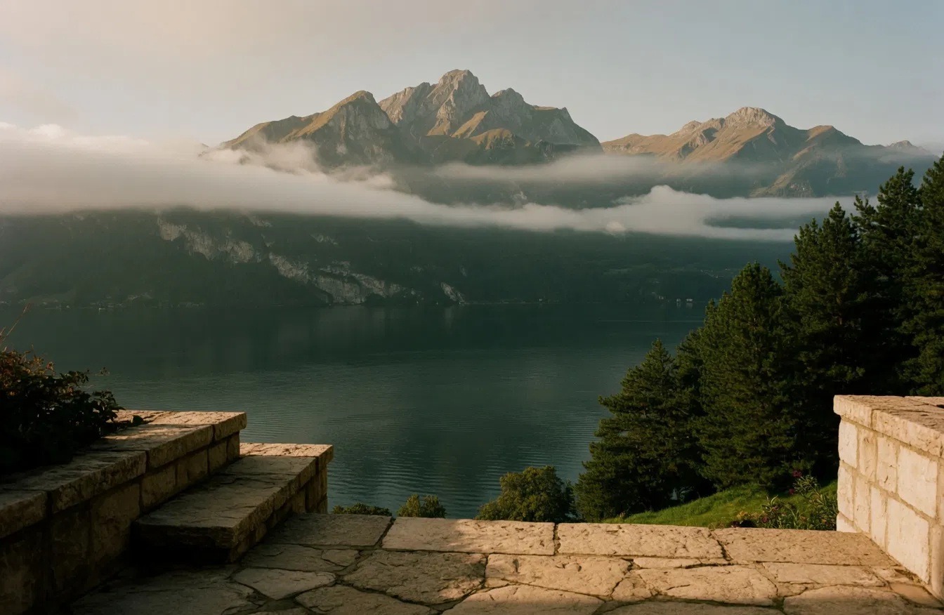 View over Lake Lucerne at dawn, mist on the mountains, from a stone terrace